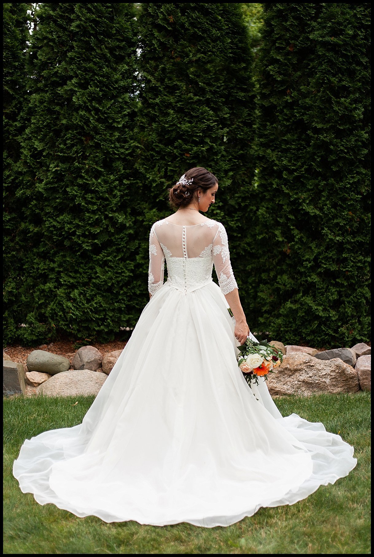 This Michigan bride wears a stunning long-sleeved wedding dress during her backyard wedding ceremony and reception in Farmington Hills, Michigan.