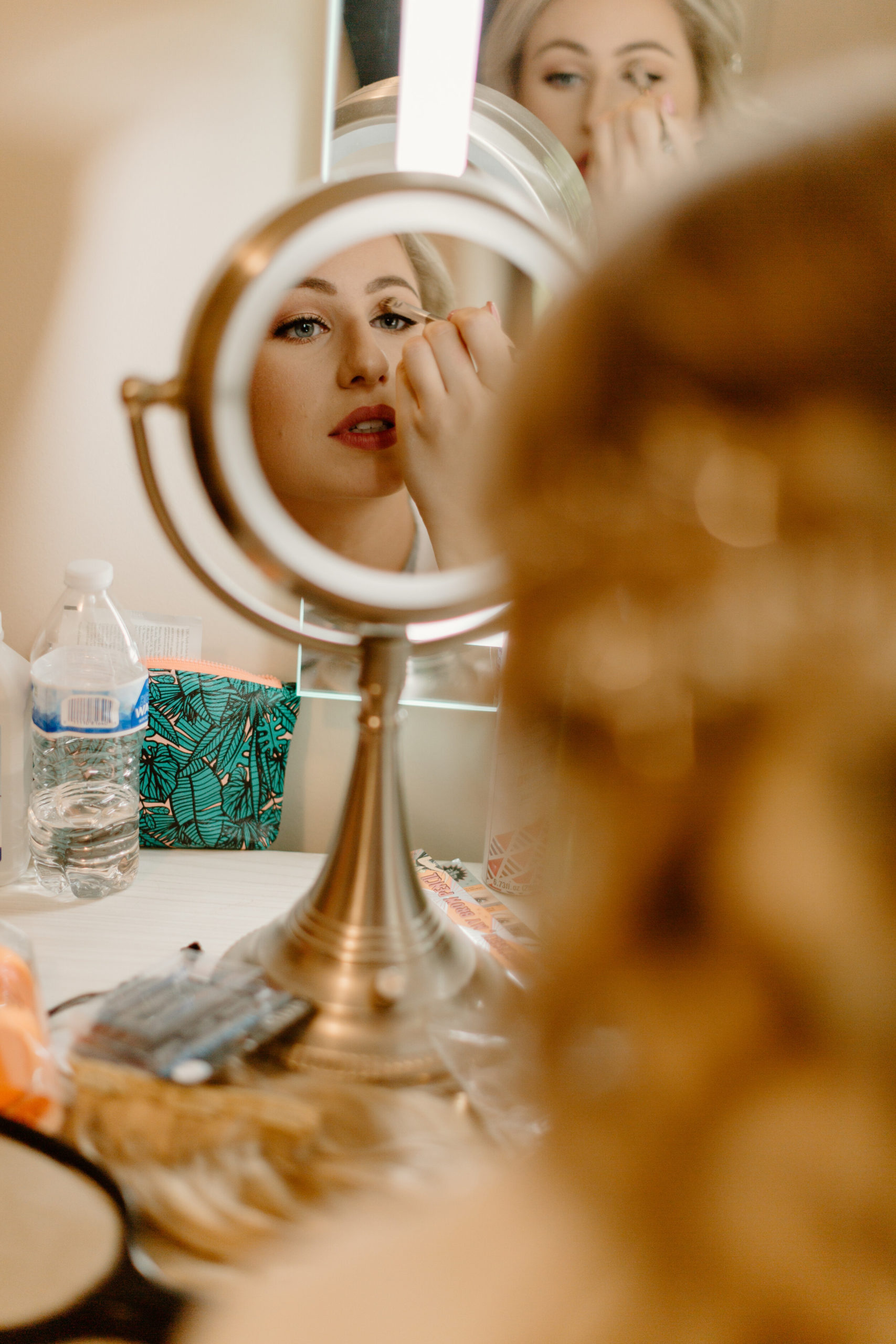 Bride putting on makeup for her wedding in Michigan