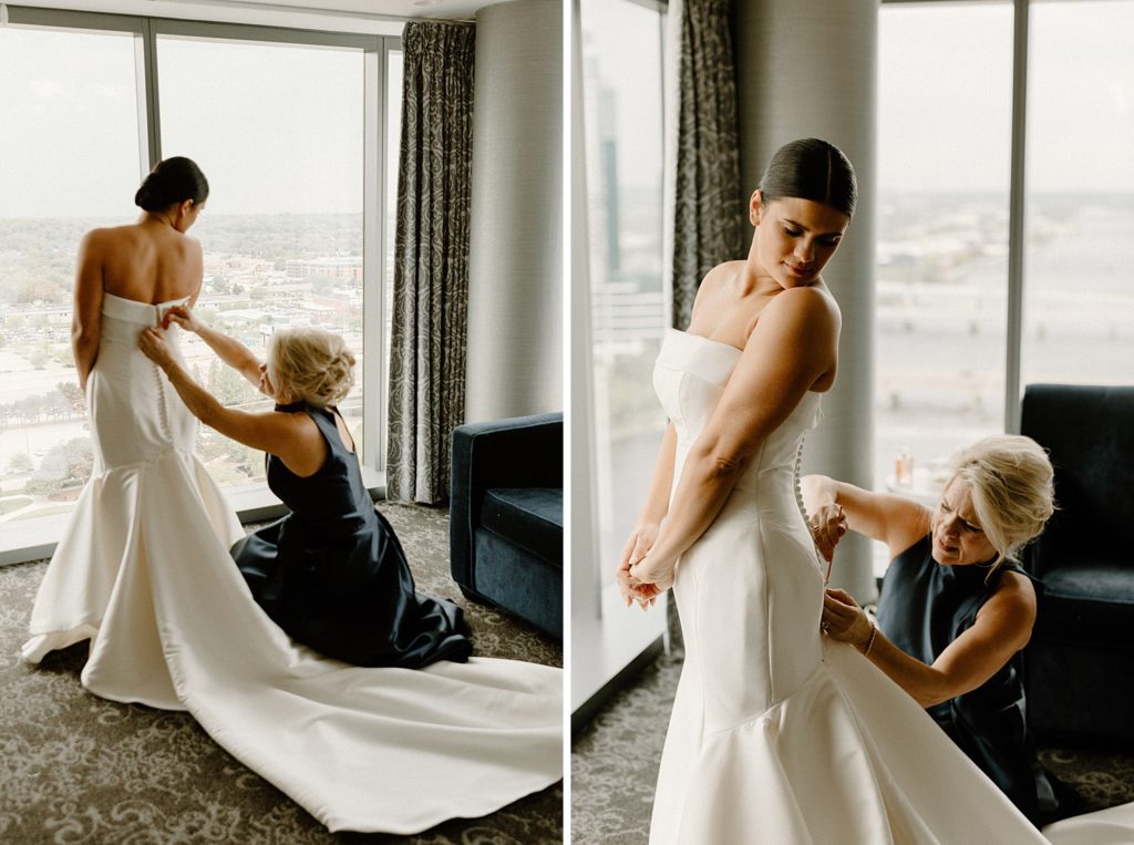 woman helping bride button up the back of her dress 