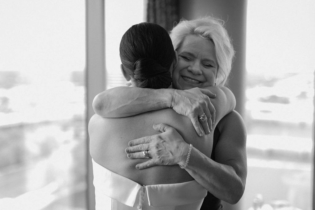 mother and bride hugging 