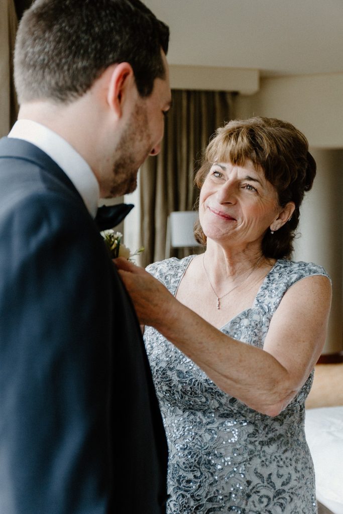 mother smiling at groom 