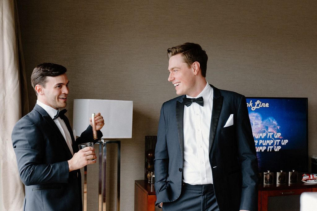 groomsmen smiling and drinking 