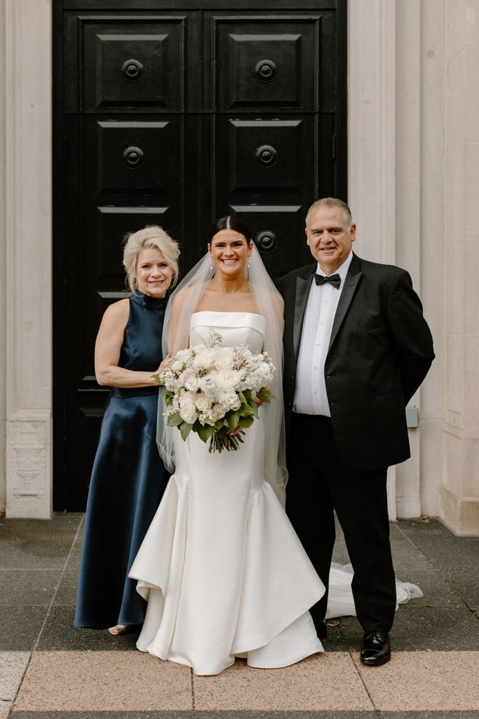bride smiling with her parents 