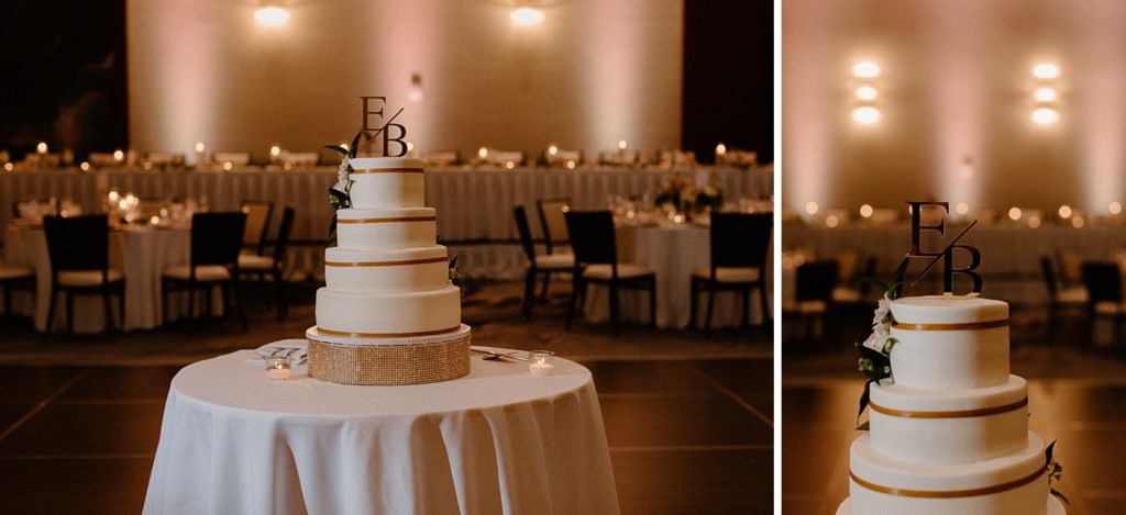 white wedding cake on a table with EB on top 