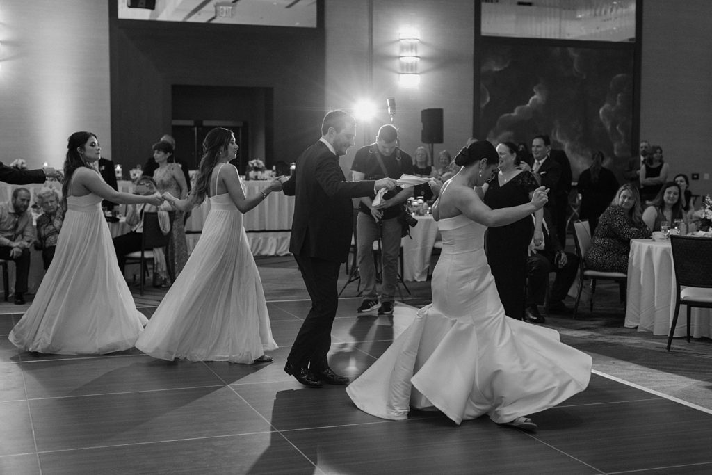 black and white photo of a group of people dancing 