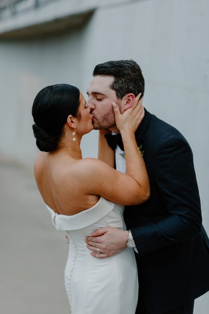 couple standing close together kissing 
