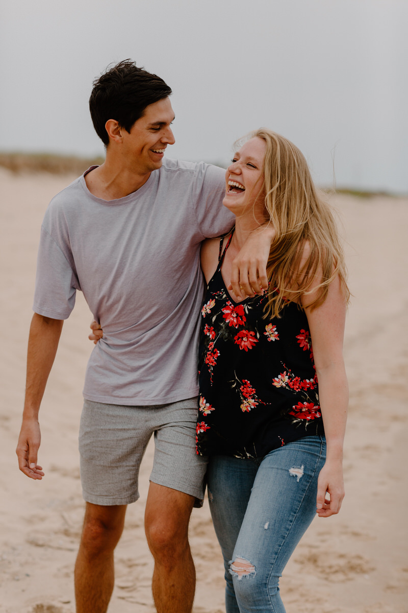 couple with their arms around each other smiling and laughing