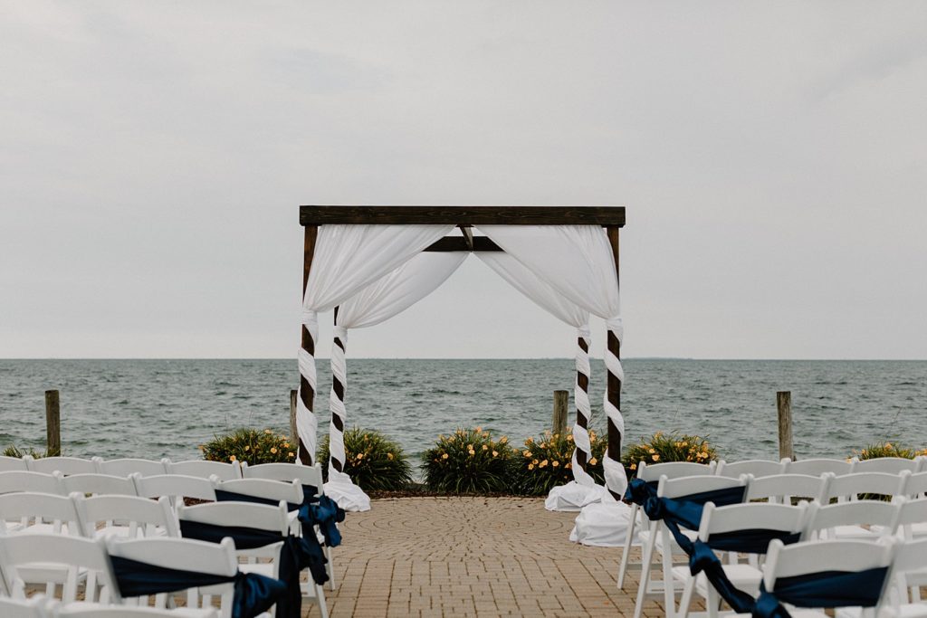 wooden arch and chairs set up on the beach